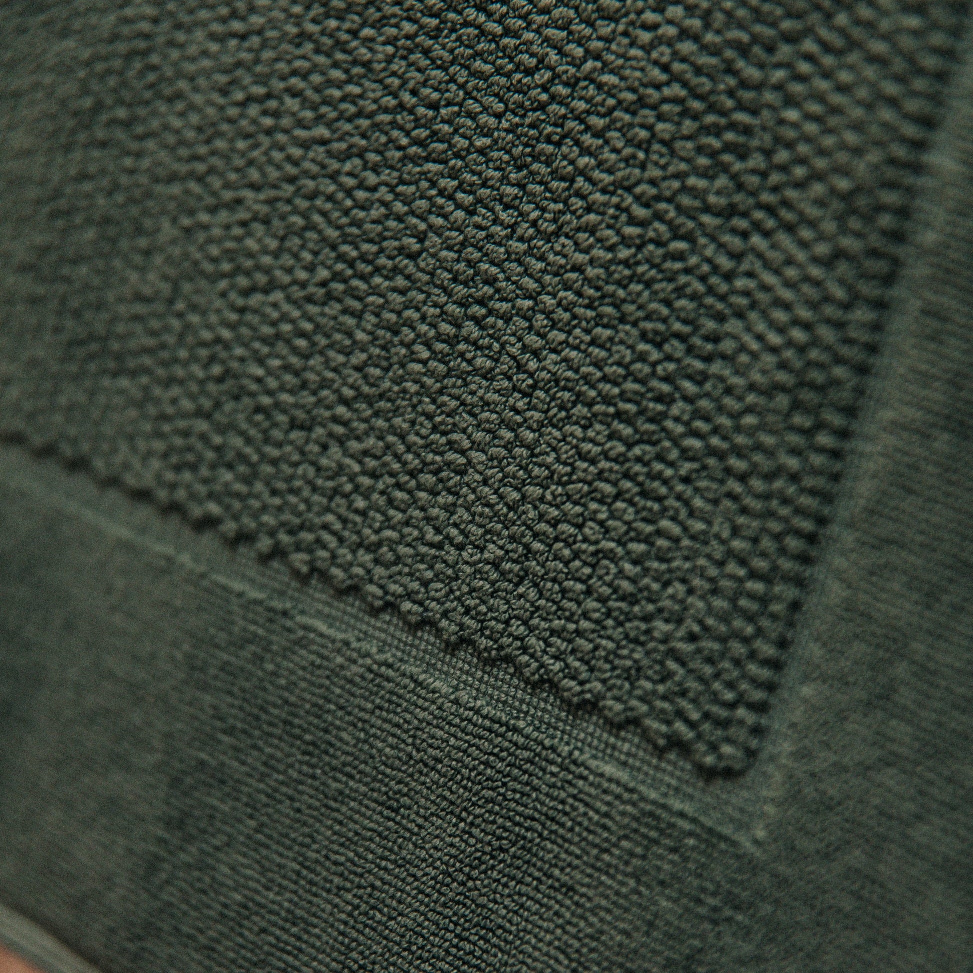 Close-up of a textured green fabric surface